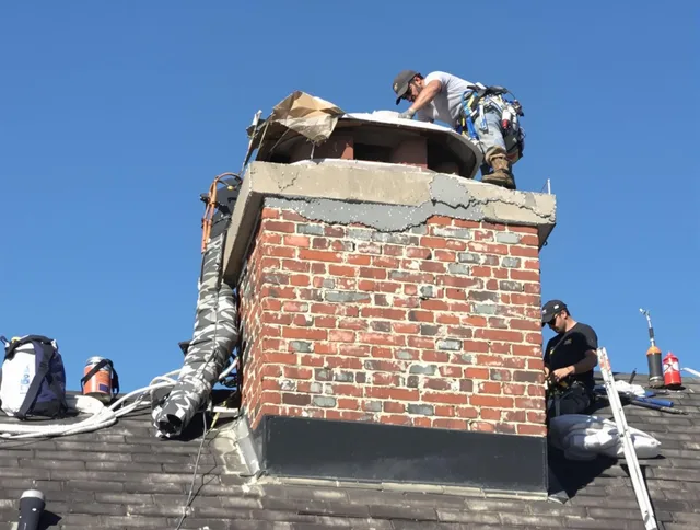 Vernon Chimney Sweep installing a custom chimney crown in Vernon, CT